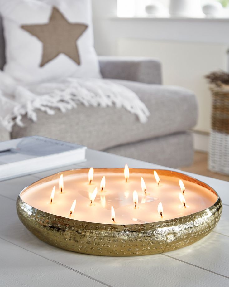 a lit candle sitting on top of a coffee table