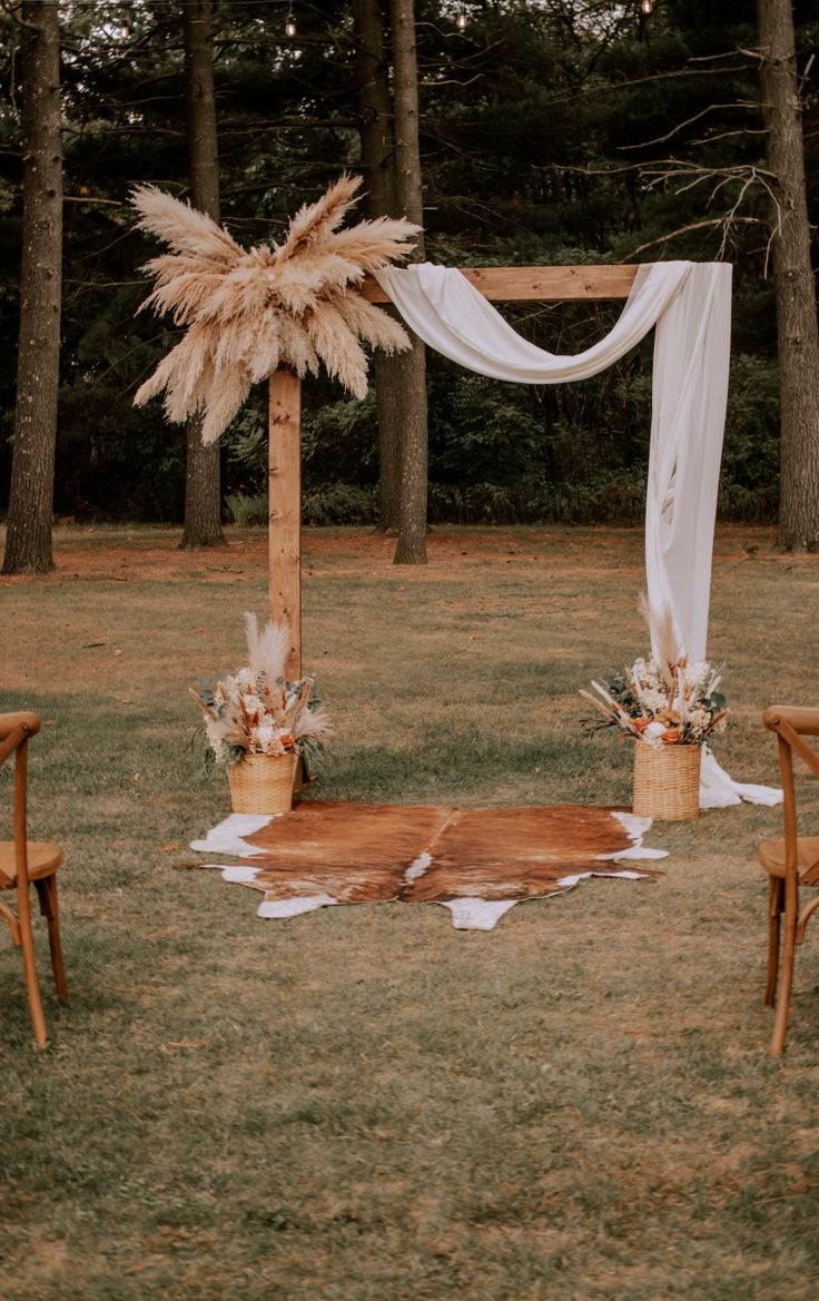 an outdoor ceremony setup with chairs and flowers