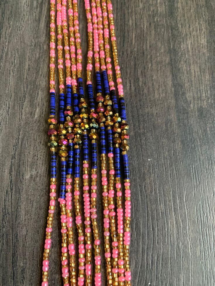 Introducing 'Meryl,' where pink, gold, and purple unite in perfect harmony! 🌸✨ Embrace the elegance and energy of these waist beads that bear her name. Adorn yourself with Meryl and celebrate the beauty of color and style. These beads are exclusively available in a tie-on style, constructed using durable cotton/polyester threads. They measure 45"-50” in length and can be self-adjusted to fit your waist size. ★ The prices listed are for a single strand. If you wish to purchase multiple strands, Pink Spacer Bead Necklaces For Festivals, Pink Spacer Beads Necklace For Festival, Pink Spacer Beaded Necklace For Festivals, Bohemian Multicolor Waist Beads With Gold Beads, Spiritual Multicolor Waist Beads With Tiny Beads, Pink Tiny Beaded Bracelets For Party, Pink Beaded Bracelets With Round Beads For Festival, Bohemian Waist Beads With Spacer Beads For Party, Pink Beaded Necklaces For Festivals