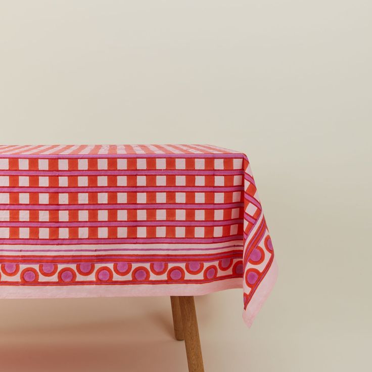 a red and white checkered tablecloth on a wooden chair with pink polka dots