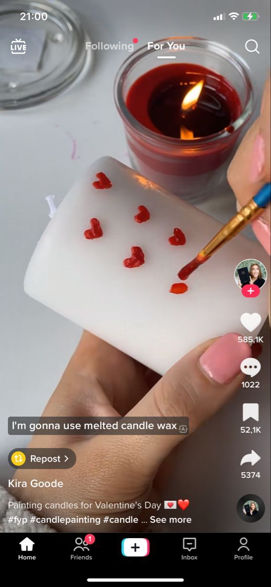 someone is painting hearts on a candle holder