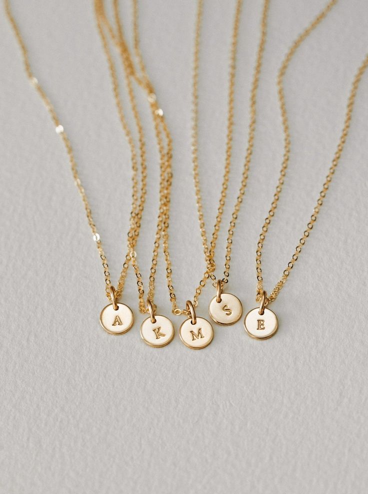 Tell a tiny story and make it all about Yue. This personalized necklace is a GLDN staple (and for good reason)! Personalize with special initials or one of over 30 symbols—the perfect anniversary gift, birthday gift or milestone gift. Each piece is hand-personalized in our studio with traditional metal punches, and available in top-quality 14k gold fill, sterling silver, rose gold fill and 14k solid gold. Another reason to love this piece: you can add extra disks as your story grows! Dainty 14k Gold Filled Engraved Charm Necklaces, Tiny Initial Pendant Charm Necklace For Gifts, Everyday Tiny Initial Pendant Charm Necklace, Dainty Initial Pendant Charm Necklace For Gift, Dainty Initial Pendant Charm Necklace As Gift, Dainty Charm Necklace With Initial Pendant As A Gift, Dainty Initial Pendant Name Necklace With Charms, Minimalist 14k Gold Filled Charm Necklace For Anniversary, Simple Round Pendant Charm Necklace As Gift