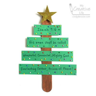 a christmas tree made out of green paper with words on it and a gold star