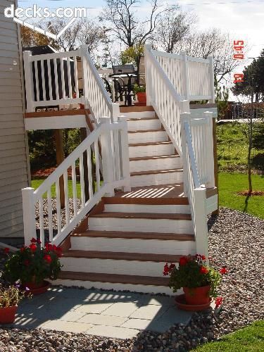 a white stair case next to a house