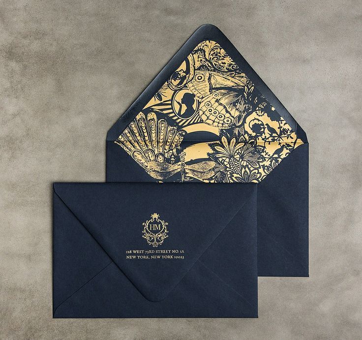 a blue envelope with gold foil on the front and bottom, featuring an ornate design