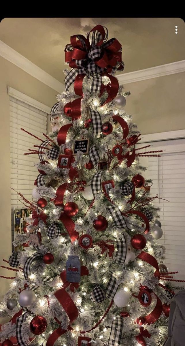 a christmas tree decorated with red, white and silver ornaments