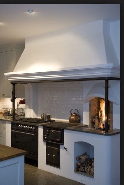 a kitchen with an oven, stove and counter top in the middle of it's room