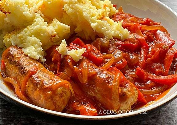 a white bowl filled with meat and vegetables