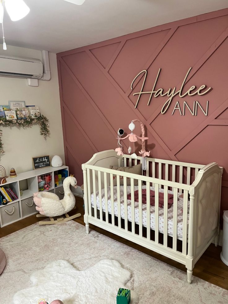 a baby's room decorated in pink and white