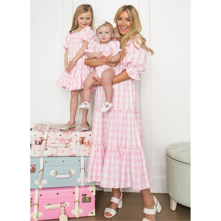 Beautiful Mommy & Me Matching dresses. The most flattering dress and in so many pretty colors! Available in six different color patterns. Momma's sizes: S-XL Girls' sizes: 7Y-12Y Good things take time. This dress ships directly to you from our overseas warehouse, and will arrive in approximately 7-15 business days. Gingham Dress With Short Sleeves For Garden Party, Cute Tiered Dress For Daywear, Cute Tiered Dresses For Daywear, Summer Gingham Tiered Dress, Tiered Gingham Dresses For Summer, Summer Tiered Gingham Dress, Cute Pink Midi Dress, Pink Tiered Cotton Dress, Cute Gingham Dress With Short Sleeves