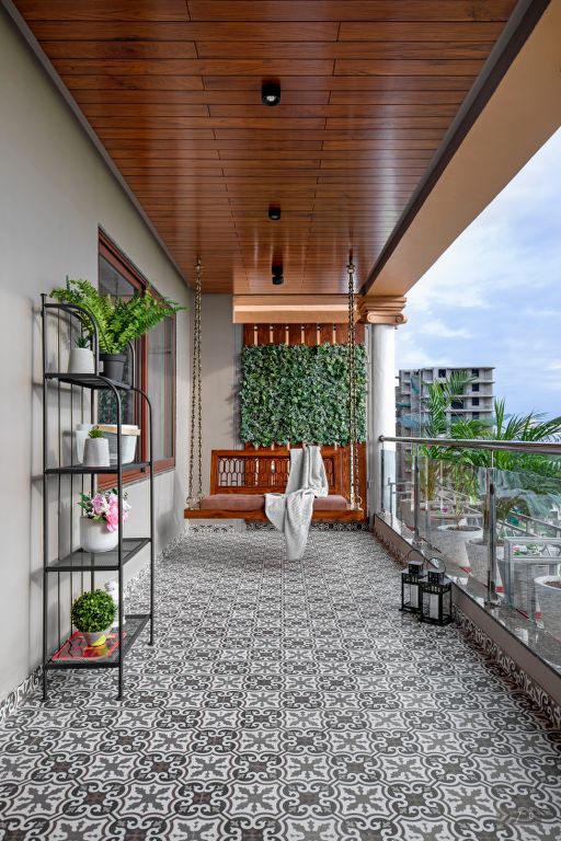 a balcony with potted plants and hanging planters