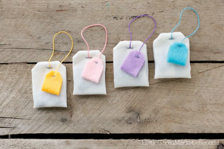 four small bags with different colored tags hanging from them