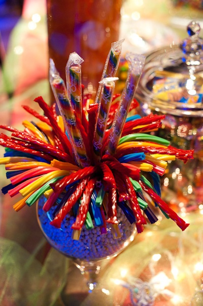 colorful straws in a blue vase on a table