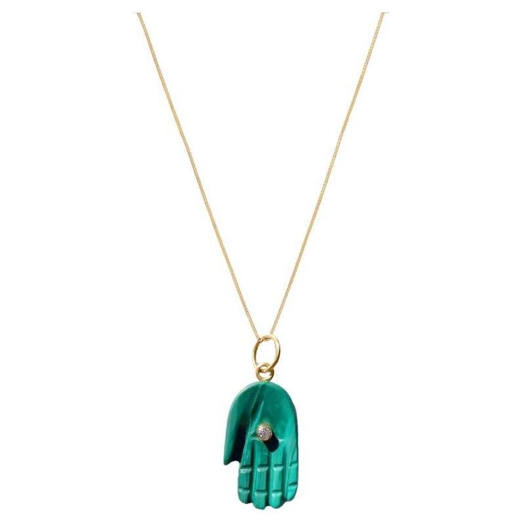 Malachite Diamond Gold Hamsa Pendant. Peace and Protection for all with the universal symbol of the Hamsa featuring a pendant in luminous natural green malachite with a center gold encased diamond 'eye’. - Green Malachite apprx 35 carats. - Set with an 18k gold encased brilliant cut diamond .10 carats and a gold jump ring. - Pendant dimensions 23 mm tall, 13 mm wide. - Suspended on a fine gold chain 18 inches. Green Malachite Necklace Spiritual Style, Luxury Malachite Gemstone Necklace, Artisan Malachite Pendant Necklace, Spiritual Malachite Pendant Necklace, Green Malachite Spiritual Jewelry, Hamsa Pendant, Gold Hamsa, Green Malachite, Diamond Eyes