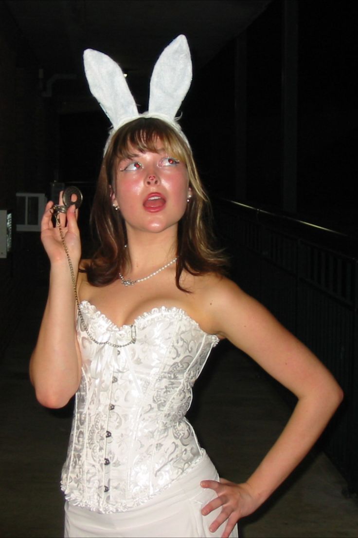 a woman wearing bunny ears is posing for the camera