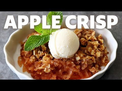 an apple crisp in a white bowl with ice cream on top and the words apple crisp above it