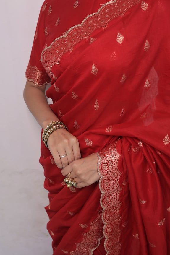 Red saree crafted in moonga silk with gold toned mughal flora vine woven detail along the scallop border and damask butti detail. Paired with a matching half sleeves closed round neck blouse. - Aza Fashions Festive Red Art Silk Pre-draped Saree, Festive Red Pre-draped Art Silk Saree, Designer Red Cotton Silk Traditional Wear, Elegant Red Art Silk Blouse Piece, Red Resham Embroidered Katan Silk Sets, Red Katan Silk Sets With Resham Embroidery, Designer Red Blouse Piece With Zari Weaving, Elegant Blouse Piece For Puja And Navratri, Elegant Navratri Blouse Piece For Puja