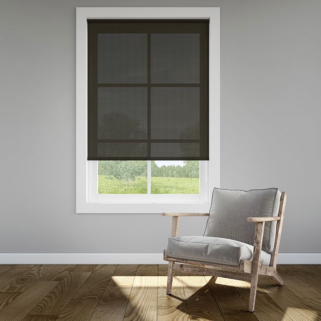 a chair sitting in front of a window with blinds on the top and bottom windowsill