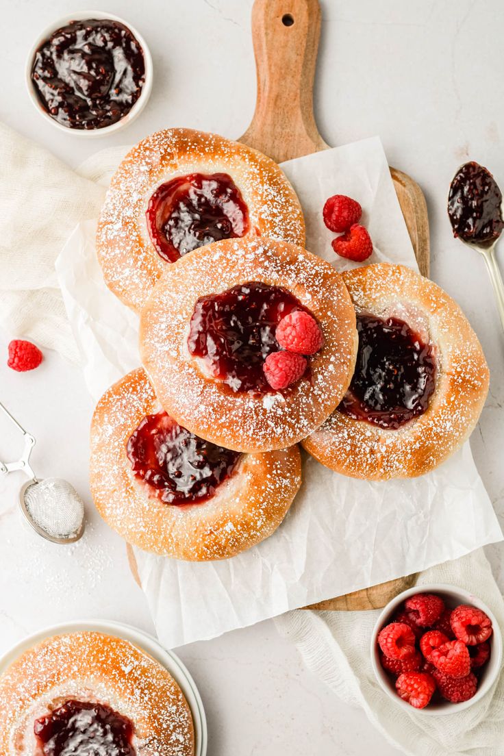 raspberry shortbreads with powdered sugar and jam on the top, ready to be eaten