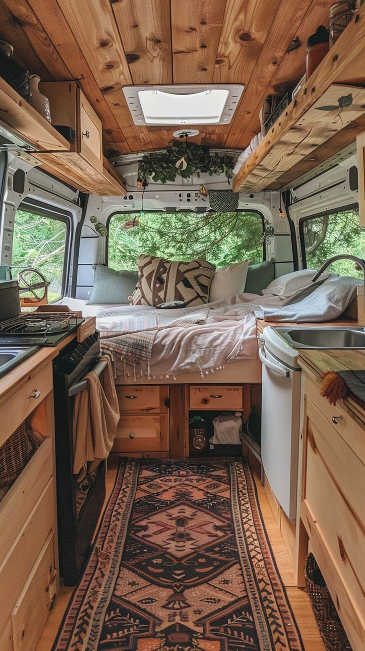 the interior of a camper van with wood paneling and white appliances in it