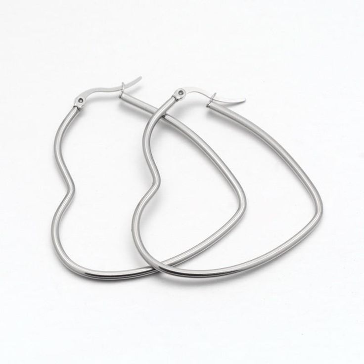 These nickle-free stainless steel heart-shaped hoop earrings are genltle to the skin and ideal for sensitive ears. Product Details: Material: Hypoallergenic; nickle free stainless steel Size: about 46mm wide, 51mm long, 2mm thick, Pin: 1x0.6mm. Detailed Necklace, Heart Hoop Earrings, Steel Earrings, Silver Jewelry Fashion, Cz Stud Earrings, Zirconia Earrings, Fashion Jewelry Earrings, Wood Earrings, Stainless Steel Earrings