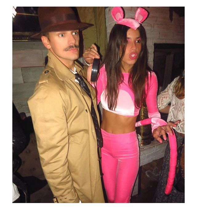 a man and woman dressed up as pink bunny ears, one holding a cell phone to her ear