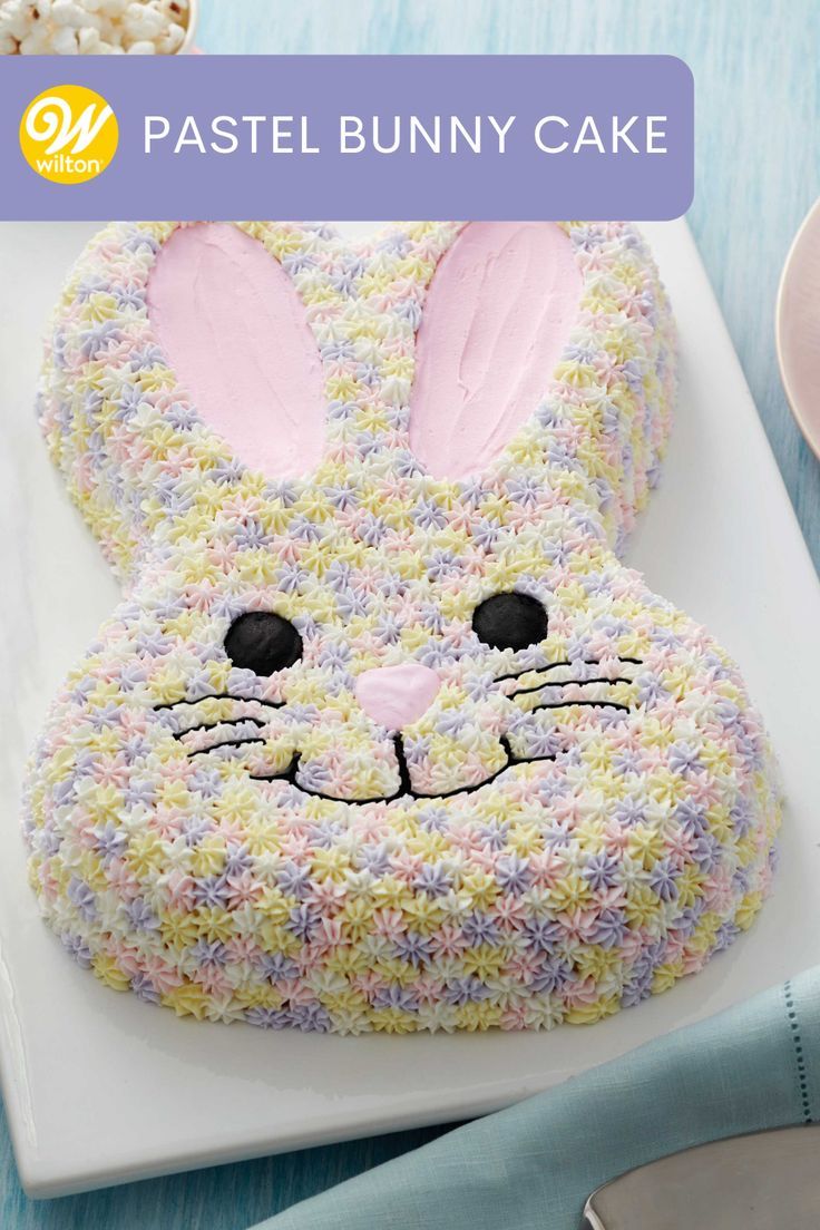 an easter bunny cake is decorated with sprinkles and has a rabbit's face on it