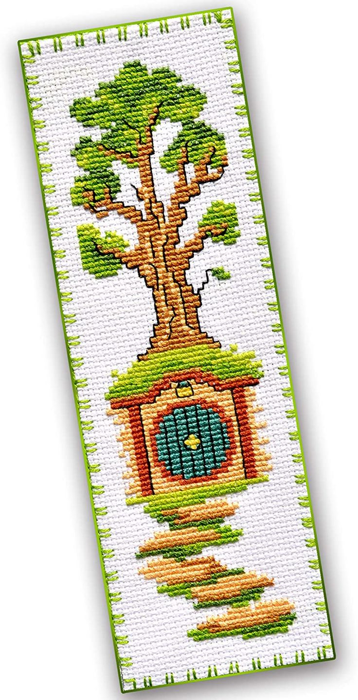 a cross stitch bookmark with a tree on it and a house in the middle