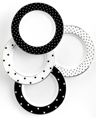 four black and white plates stacked on top of each other in the shape of circles