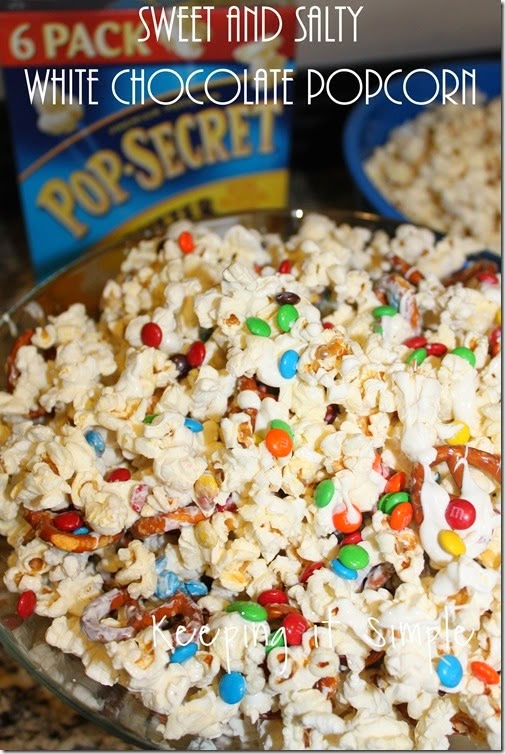 white chocolate popcorn with m & m candies in the middle and candy on top