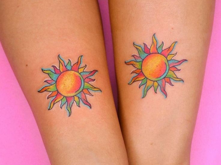 two sun tattoos on both legs