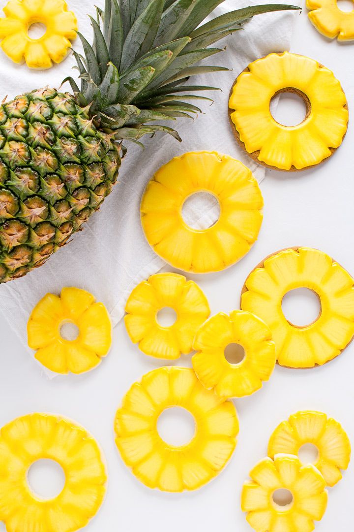 pineapple slices and sliced pineapples on a white surface