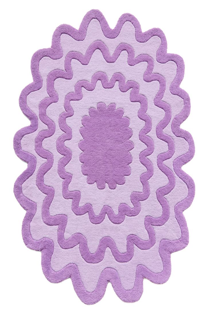 a purple rug with an intricate design on the top and bottom, is shown in front of a white background