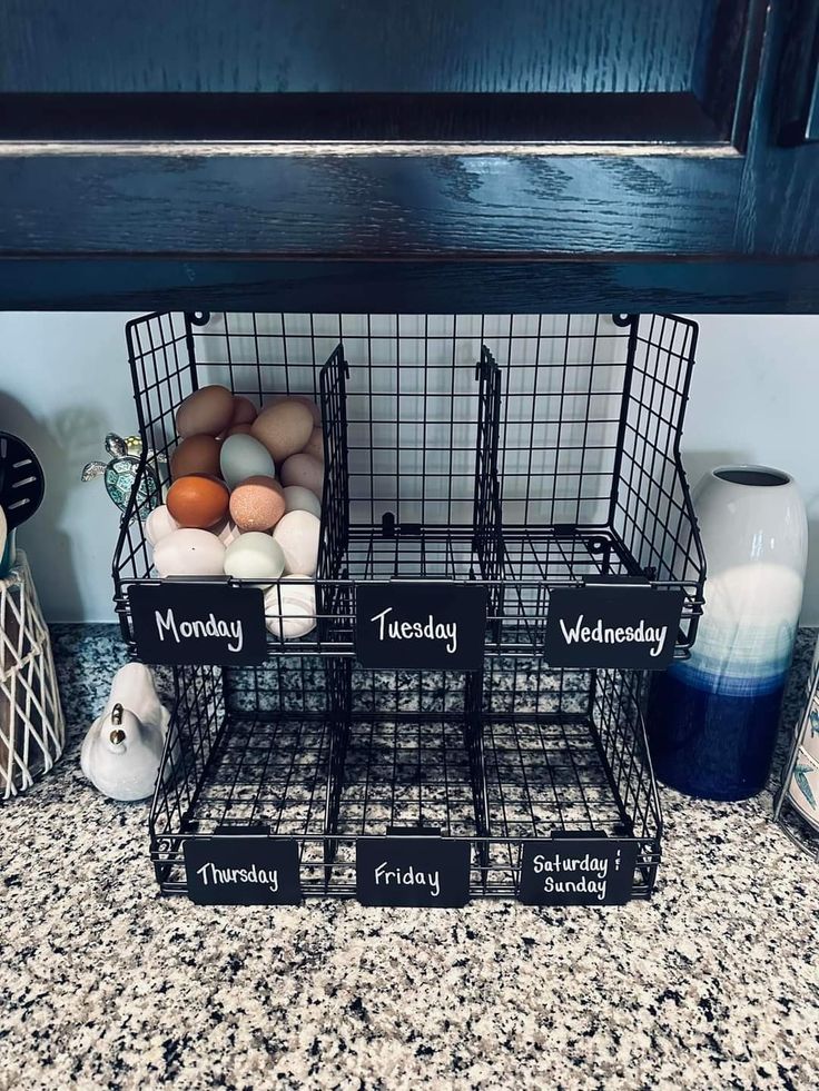 three baskets filled with eggs sitting on top of a counter