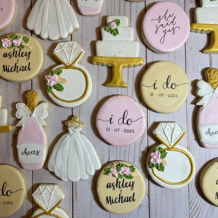 wedding cookies decorated with bride and groom's names are displayed on a white table