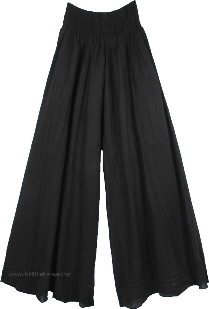 A pair of palazzo pants in black that you can wear in every season, these pants are extremely comfortable and are made of light weight fabric. The bottom of the pants is very wide, which gives it a flow and a feminine look as you walk. These pants have pin tuck details at the bottom near the hemline. Perfect for summer evenings out with friends, you can simply wear these casual wide leg pants with a solid top of any color you like according to the occasion. Wear some jewelry to enhance your bohe Wide Leg Cotton Pants, Big Pants, Black Palazzo Pants, Desi Wedding Dresses, Hippie Look, Black Wide Leg Pants, Trendy Skirts, Casual Wide Leg Pants, Split Skirt