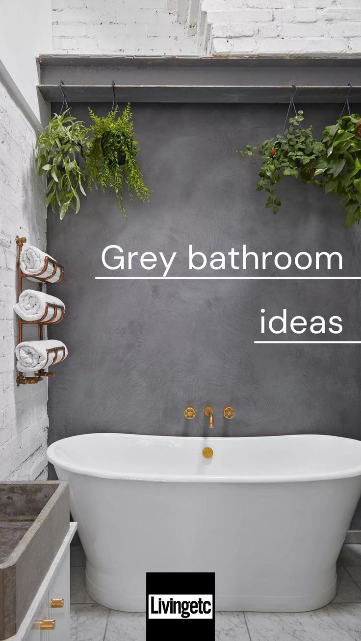 a white bath tub sitting next to a wall with plants hanging from it's sides