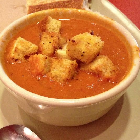 a bowl of soup with croutons in it