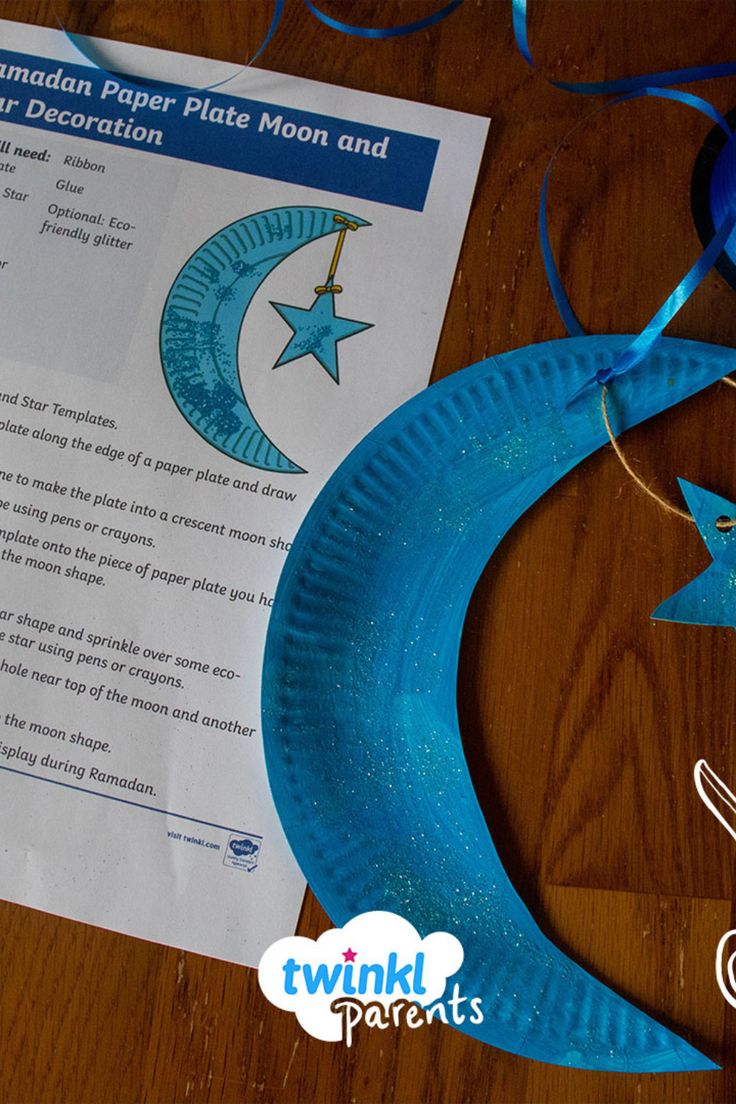 a paper plate moon and star decoration on a wooden table with twink's