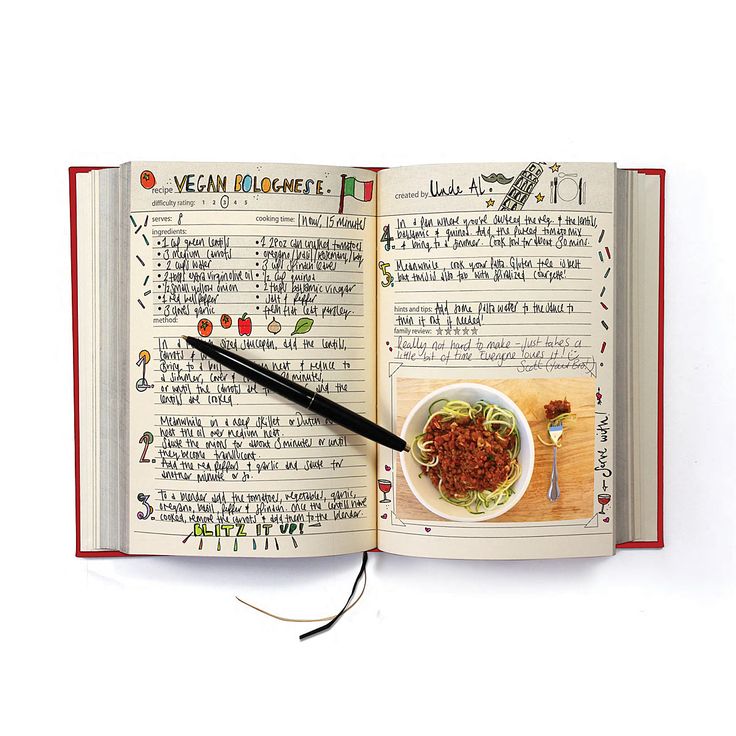 an open book with a bowl of food and a pen on top of the page