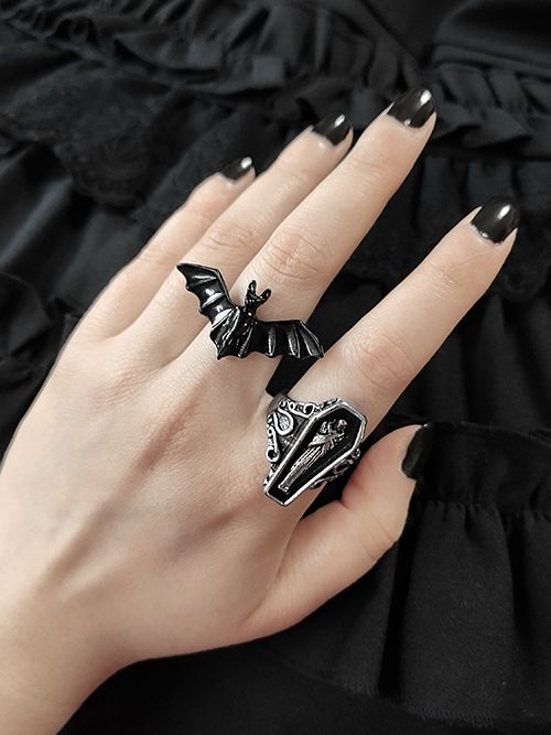 Embrace your gothic style with this striking vampire bat/coffin ring. This unisex ring features intricate metalwork and a vintage design, making it the perfect accessory for Halloween or any gothic-inspired outfit.   Please note that this product includes only one ring. Goth Jelewery, Punk Black Rings For Halloween, Black Punk Rings For Halloween, Punk Black Ring For Halloween, Black Metal Rings For Halloween, Vintage Black Rings For Halloween, Gothic Black Skull Ring, Gothic Black Skull Ring For Halloween, Edgy Metal Rings For Halloween