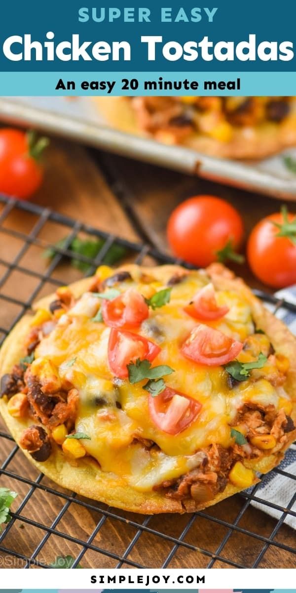 an easy chicken tostadas recipe on a cooling rack with tomatoes in the background