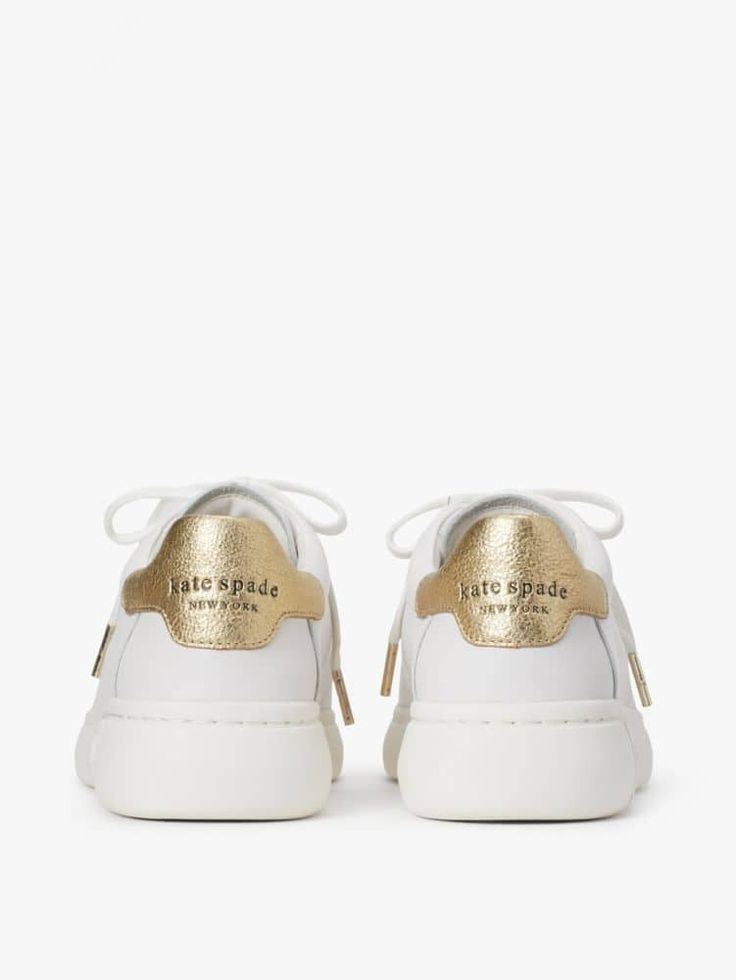 we call these our lift sneakers for a reason: the platform midsoles will add a little bit of height plus the supple nappa leather with pops of print and color will instantly elevate any outfit you pair them with. | Kate Spade Lift Sneakers, Optic White/Pale Gold - 11 Gold Leather Sneakers With Rubber Sole, Chic Lace-up Sneakers With Rubber Sole, Gold Leather Sneakers With Laces, Leather Lace-up Shoes With White Sole, Elegant Lace-up Sneakers With White Sole, Calf Leather Lace-up Shoes With Textured Sole, Gold Leather Sneakers, Luxury Low-top Lace-up Shoes In Calf Leather, Designer Leather Sneakers With Laces