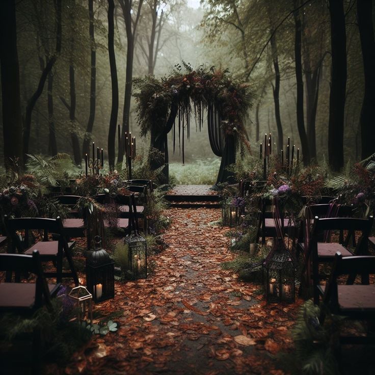 an outdoor ceremony set up in the woods with candles and flowers on the aisle, surrounded by trees