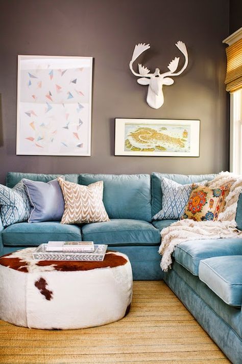 a living room filled with blue couches and pillows