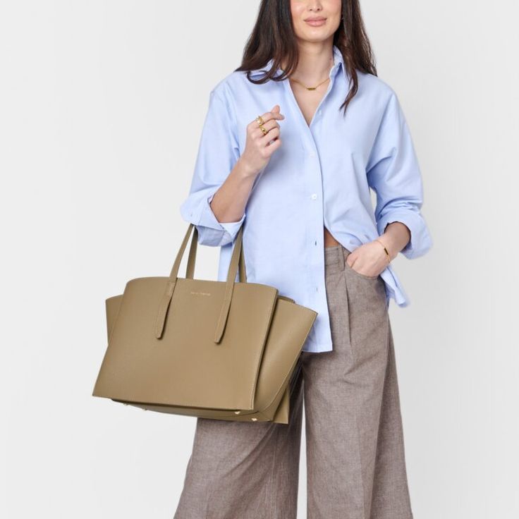 Designed to enhance your daily routine, our Tabi Large Tote Bag in Taupe features a spacious interior that accommodates most laptop models, making it perfect for both casual and professional occasions. It also includes a removable zip pouch suitable for devices up to 13 inches, along with a D-ring for personalizing with Clip-On Accessories. Pebble vegan leather design with soft suedette lining Features shoulder straps, 3 internal compartments, removable pocket pouch, and internal D-ring for Clip Casual Office Satchel With Top Carry Handle, Casual Office Shoulder Laptop Bag, Casual Office Laptop Shoulder Bag, Casual Large Capacity Laptop Bag For Office, Rectangular Laptop Bag With Removable Pouch For Work, Office Tote Satchel With Luggage Sleeve, Office Satchel With Luggage Sleeve In Tote Shape, Office Satchel With Luggage Sleeve And Tote Shape, Office Satchel With Luggage Sleeve And Double Handle