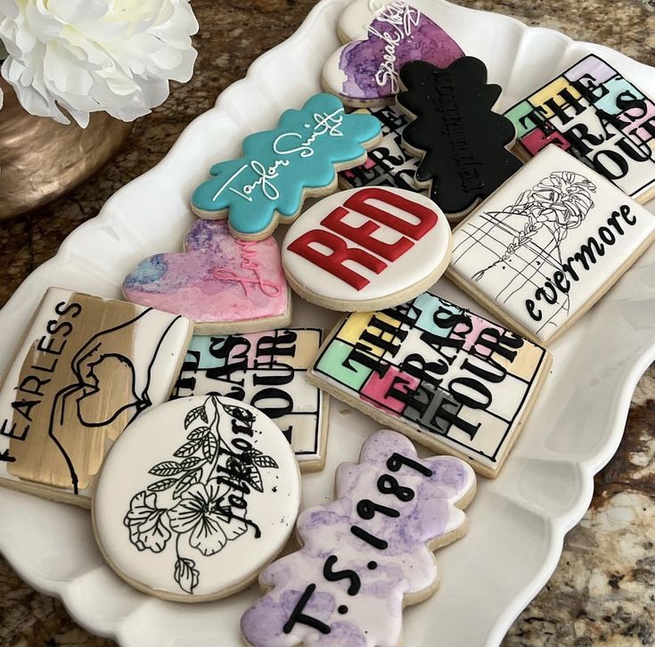 some decorated cookies are on a white plate