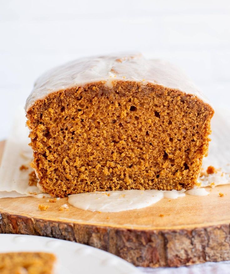 a piece of cake sitting on top of a wooden cutting board