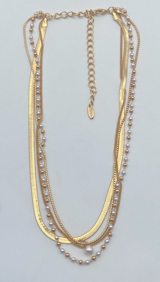 Four elegant chains in one! Each layer is meticulously crafted to drape gracefully around your neckline, creating a powerful statement piece that compliments any outfit. Why blend in when you're born to stand out? Make your fashion statement with our All the Chains 18K Gold Plated Layered Necklace. - 18kt gold plated on brass and steel for durability - Created depth with multiple 15.5" - 18.5" layers - Adjustable with a 5" extender for perfect fit Multi-strand Metal Necklace With Pearl Chain, Multi-strand Layered Pearl Chain Necklace For Parties, Multi-strand Layered Pearl Necklace For Party, Multi-strand Metal Pearl Chain Jewelry, Elegant Metal Layered Necklace With Beaded Chain, Elegant Layered Metal Necklace With Beaded Chain, Elegant Beaded Chain Layered Necklace, Elegant Layered Beaded Chain Necklace, Elegant Multi-strand Beaded Chain Layered Necklace