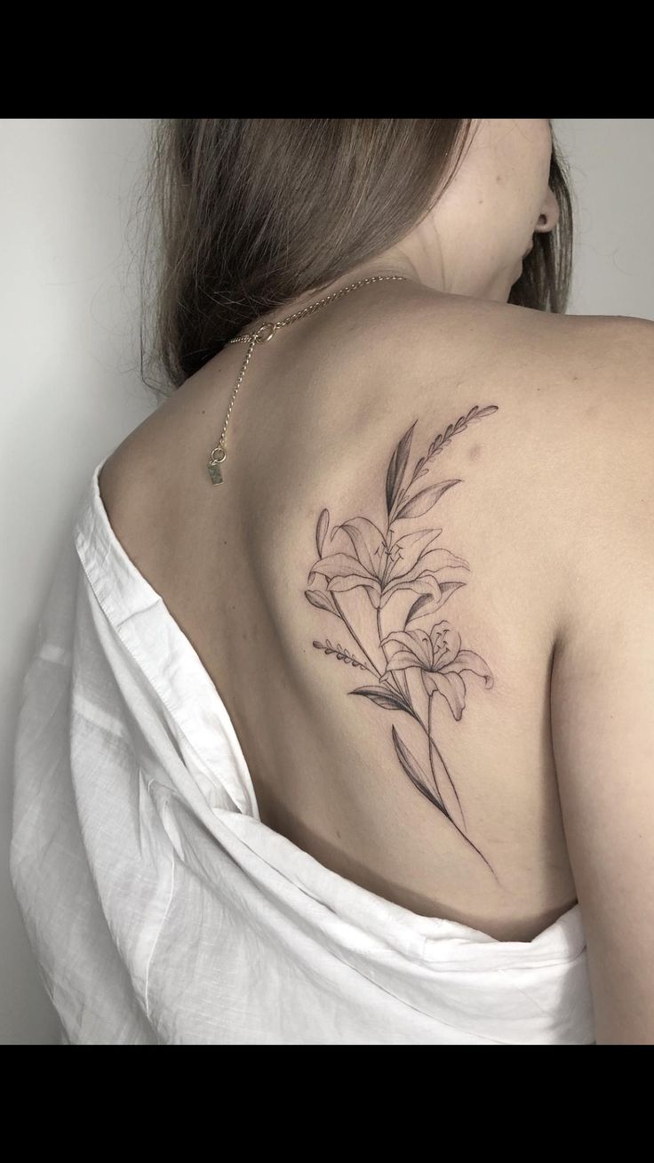 a woman with a flower tattoo on her shoulder